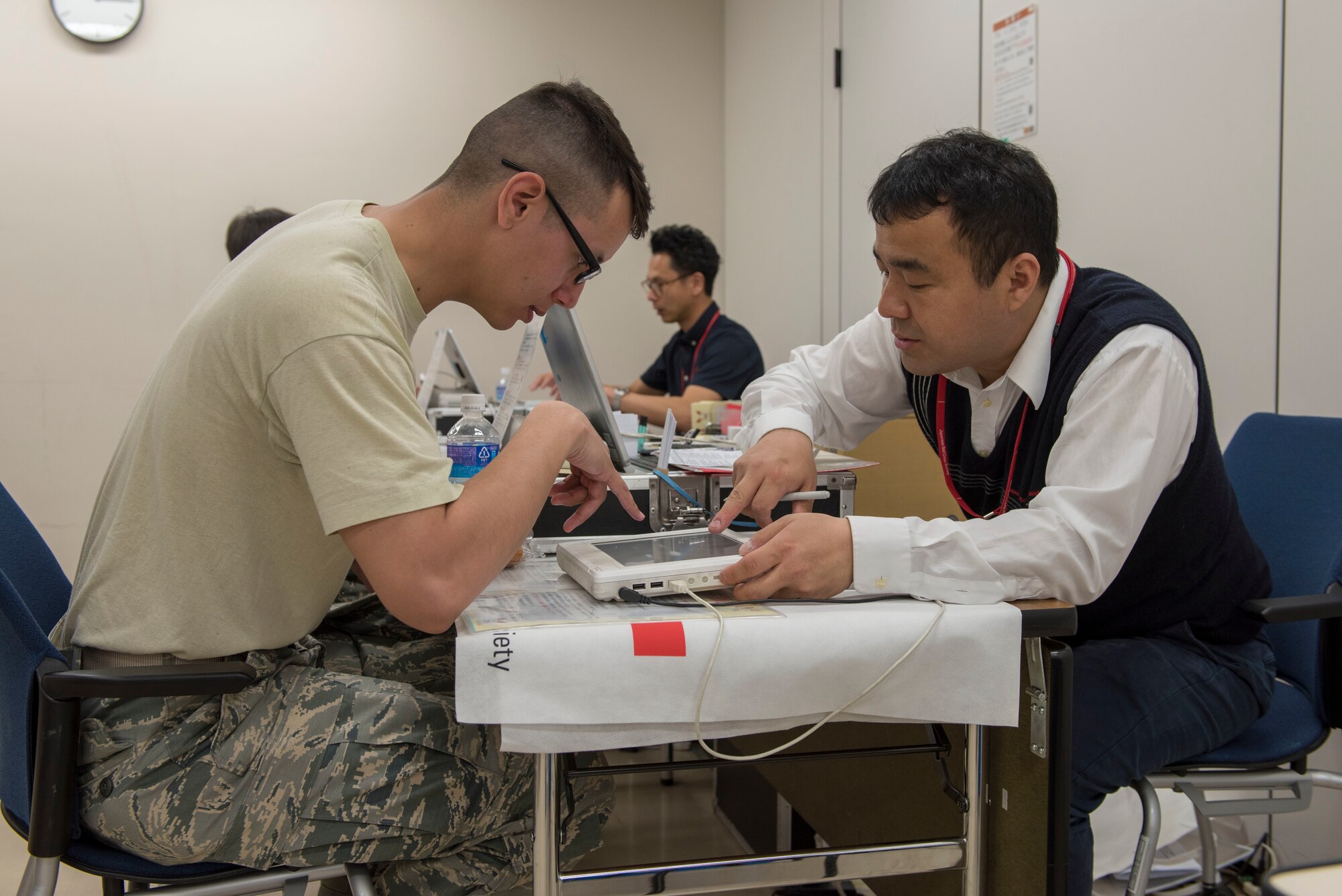 Staff Sgt. Michael Ober, 374th Operations Support Squadron NCO in charge of airfield management training, completes his medical prescreening prior to donating blood to the Japanese Red Cross Society at Yokota Air Base, Japan, March 28, 2018.
