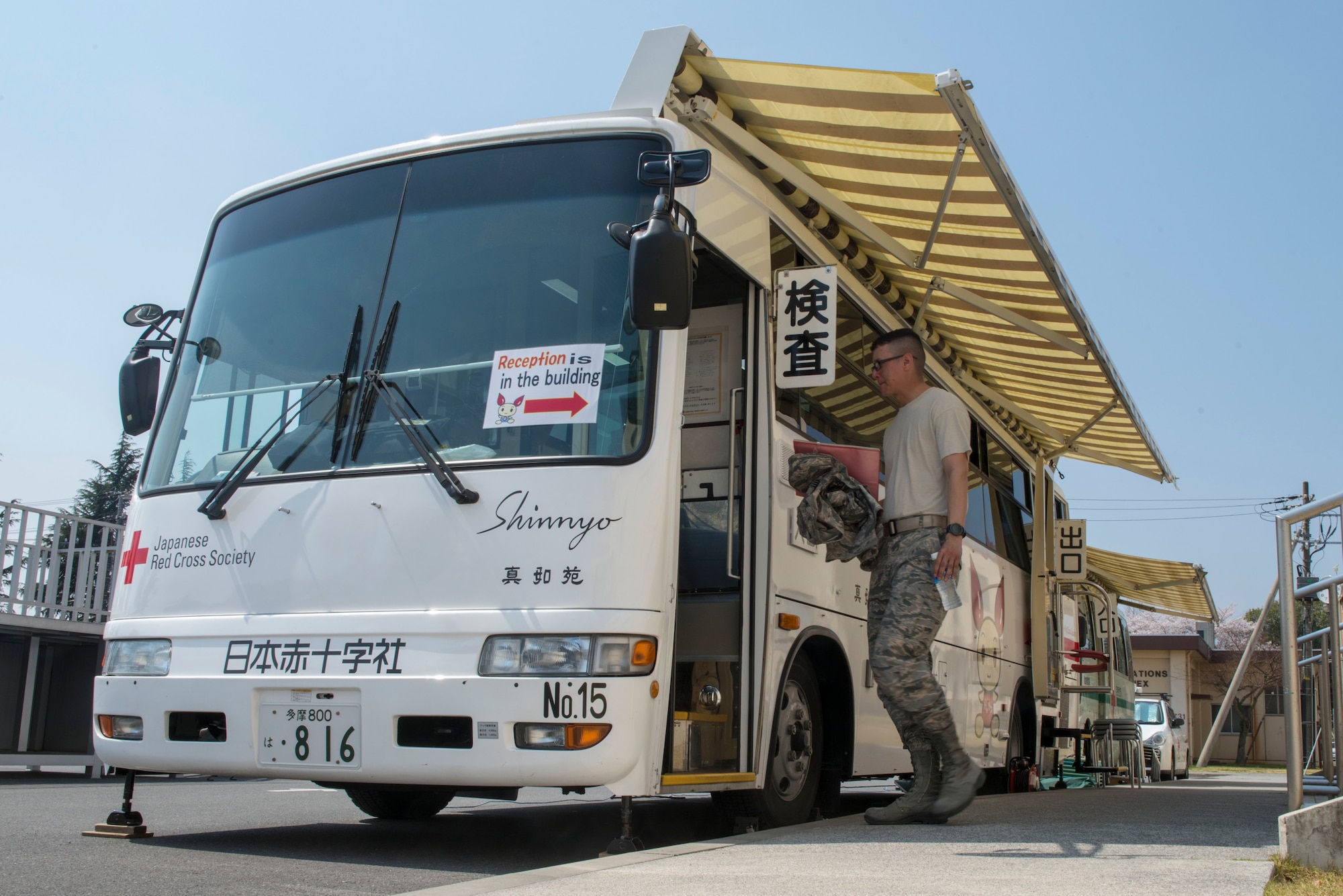 Staff Sgt. Michael Ober, 374th Operations Support Squadron NCO in charge of airfield management training, steps onto Japanese Red Cross Society bus to donate blood at Yokota Air Base, Japan, March 28, 2018.