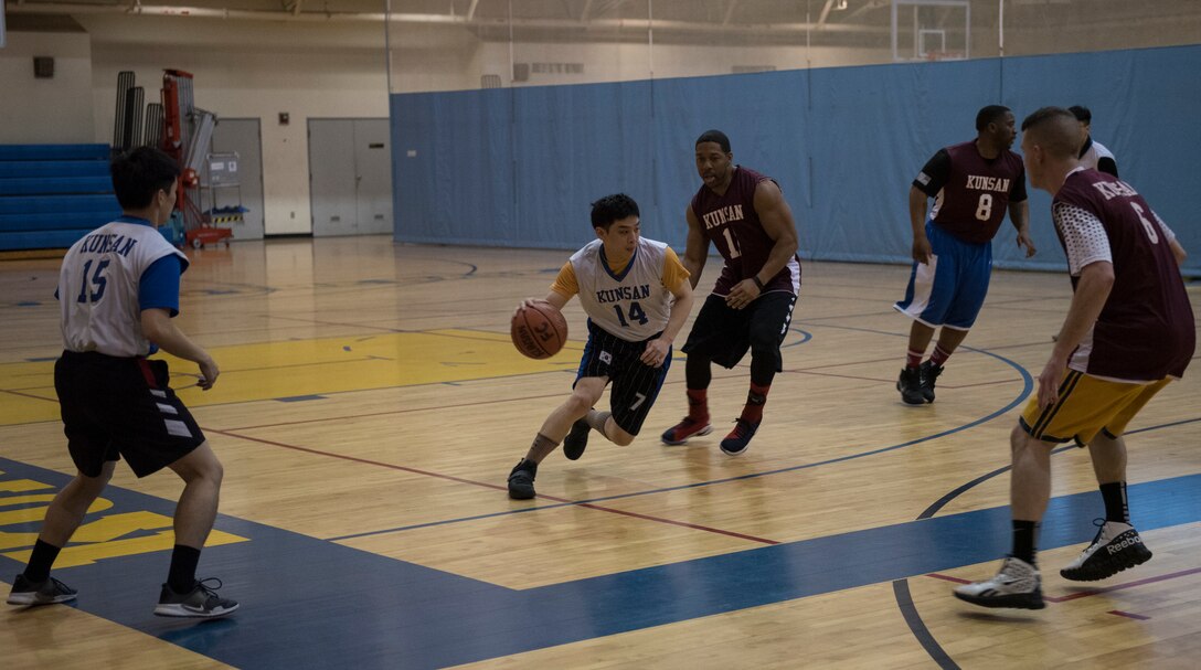 U.S. Air Force Airmen and Republic of Korea Air Force Airmen play a game of basketball during an intramural sporting event January 22, 2018, at Kunsan Air Base, Republic of Korea. Kunsan Air Base’s intramural basketball season just recently wrapped up and this season marked the first time members of the ROKAF have participated in the Wolf Pack’s unit versus unit competition. (U.S. Air Force photo by Tech. Sgt. Josh Rosales)