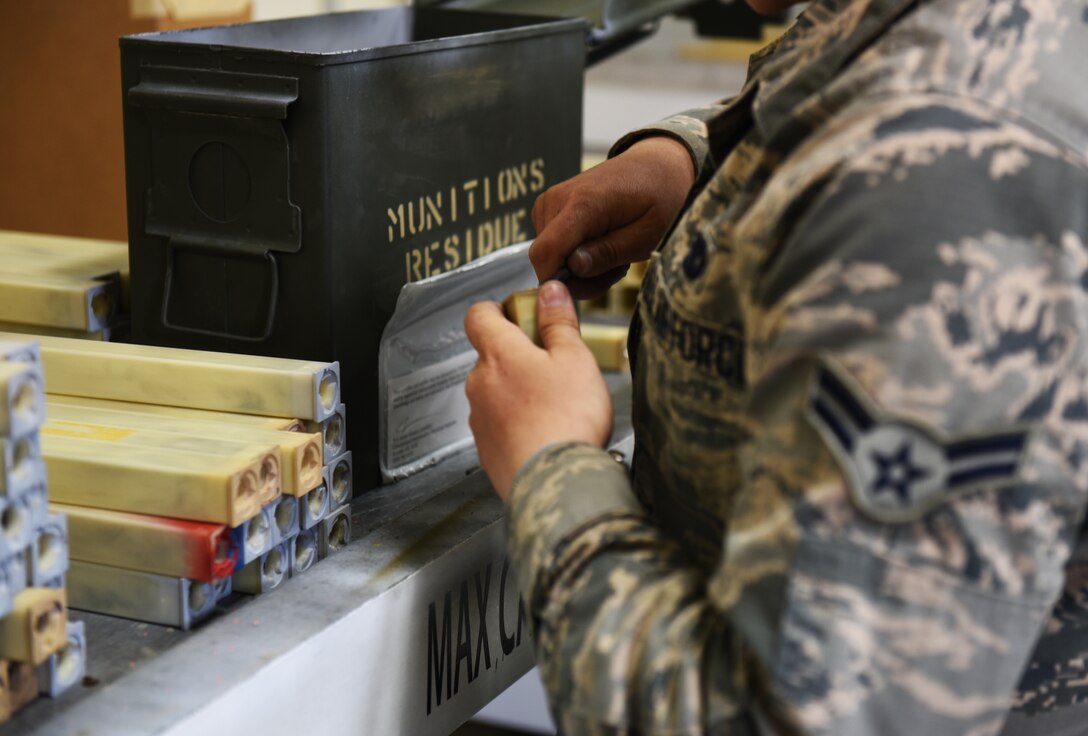 U.S. Air Force Airman 1st Class Angelica Range, conventional maintenance crew chief assigned to the 8th maintenance squadron, plucks out used chafe backs at Kunsan Air Base, Republic of Korea, March 20, 2018. Chafe and flares are used for missile target practice by pilots during aerial missions. (U.S. Air Force photo by Staff Sgt. Jasmonet D. Jackson)