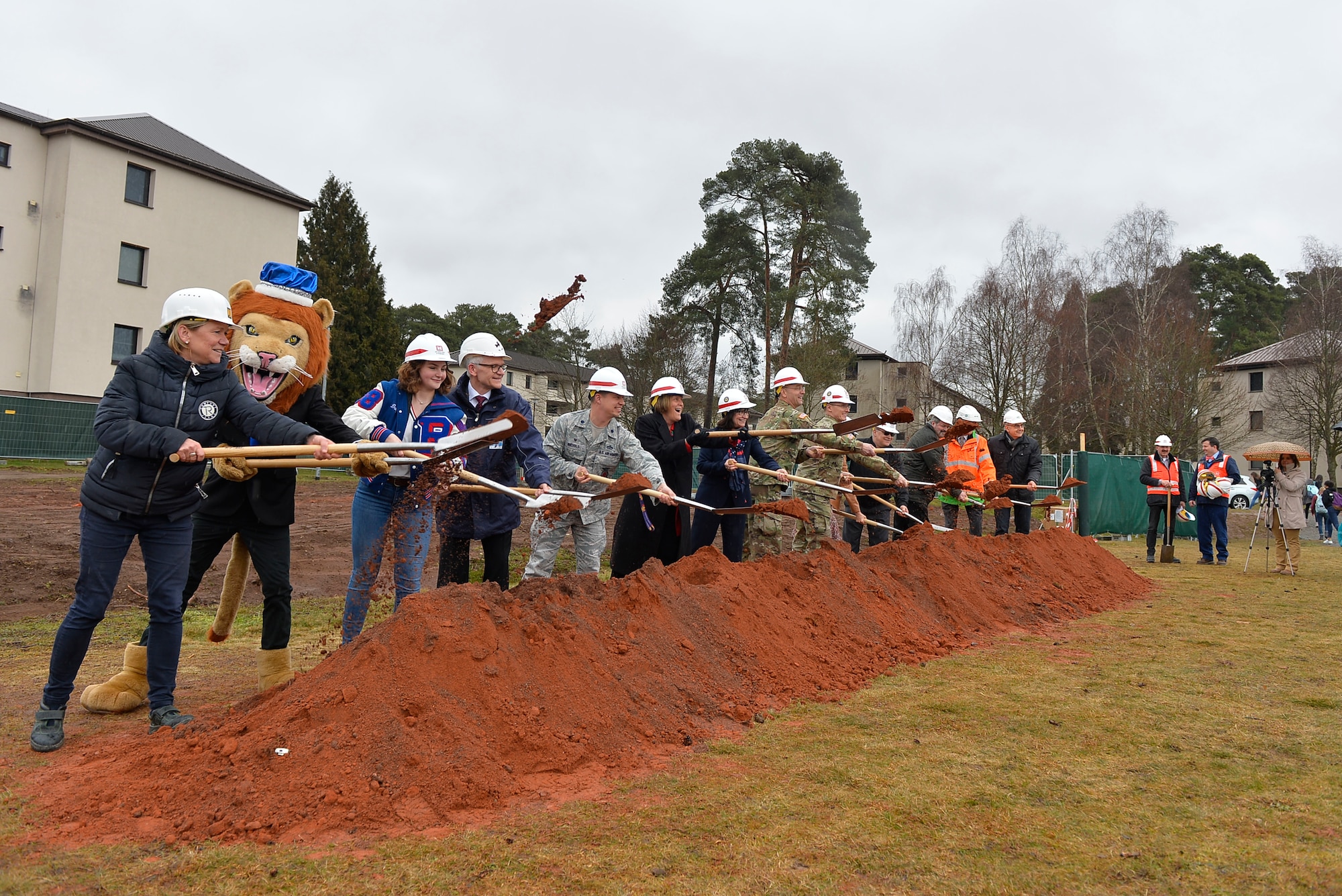Military and civilian officials conduct a groundbreaking ceremony for a new school building on Ramstein Air Base, Germany, March 28, 2018. The Kaiserslautern Military Community has pushed to replace its old school buildings with futuristic 21st century educational facilities, which are characterized by student-centeredness, energy efficiency, and flexibility to accommodate multiple learning styles. (U.S. Air Force photo by Senior Airman Joshua Magbanua)