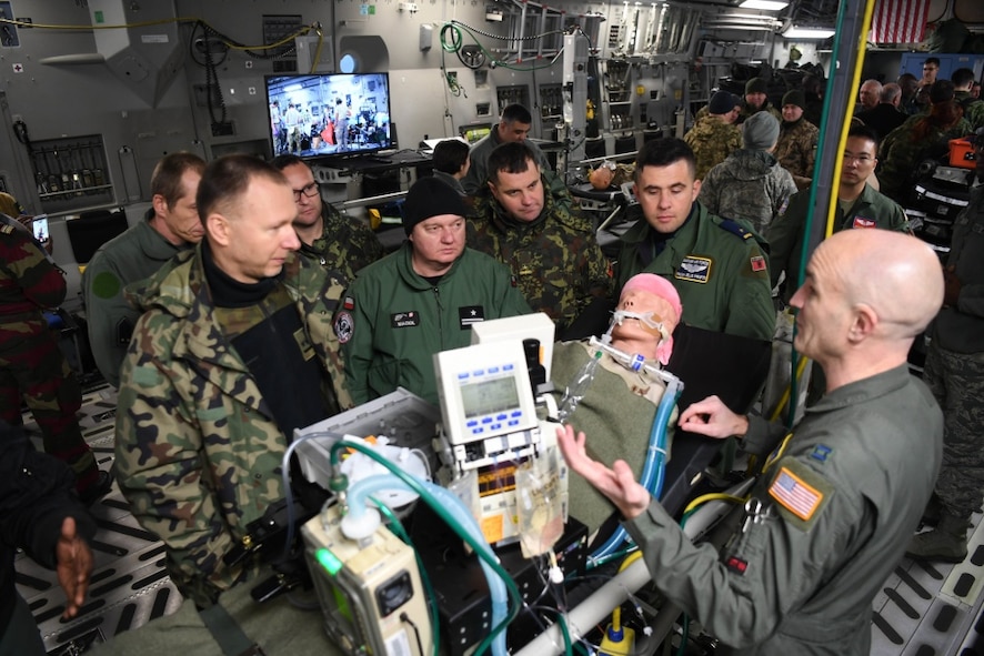 U.S. Air Force Capt. Arik Carlson, 10th Expeditionary Aeromedical Evacuation flight critical care air transport team (CCATT) nurse, explains the role of CCATT to Partnership Flight Symposium participants at Ramstein Air Base, Germany, Jan. 17, 2018. The CCATT’s mission is to operate an intensive care unit in an aircraft during flight. (U.S. Air Force photo by Tech. Sgt. Rachelle Coleman)