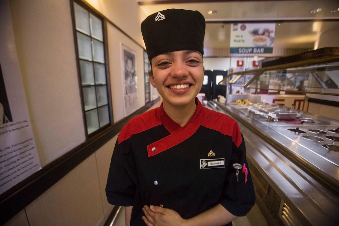 Cpl. Lexus Martinez, Marine Corps Installations Pacific Food Service Specialist of the Quarter, prepares to serve chow.