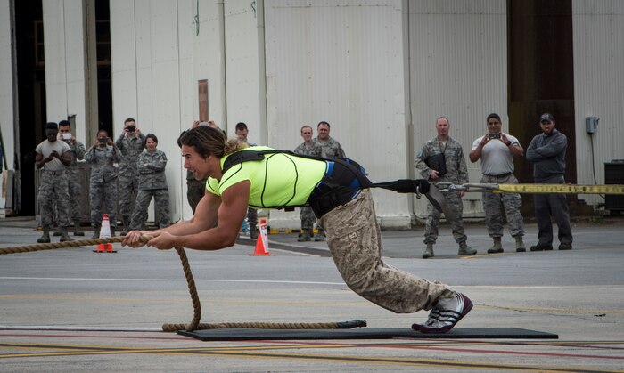 Mark Kirsch, strong man for “Man vs. Impossible,” pulls a C-17 Globemaster III from a hangar at Joint Base Charleston, S.C., March 27, 2018.