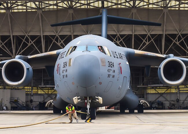 Mark Kirsch, strong man for “Man vs. Impossible,” pulls a C-17 Globemaster III from a hangar at Joint Base Charleston, S.C., March 27, 2018.