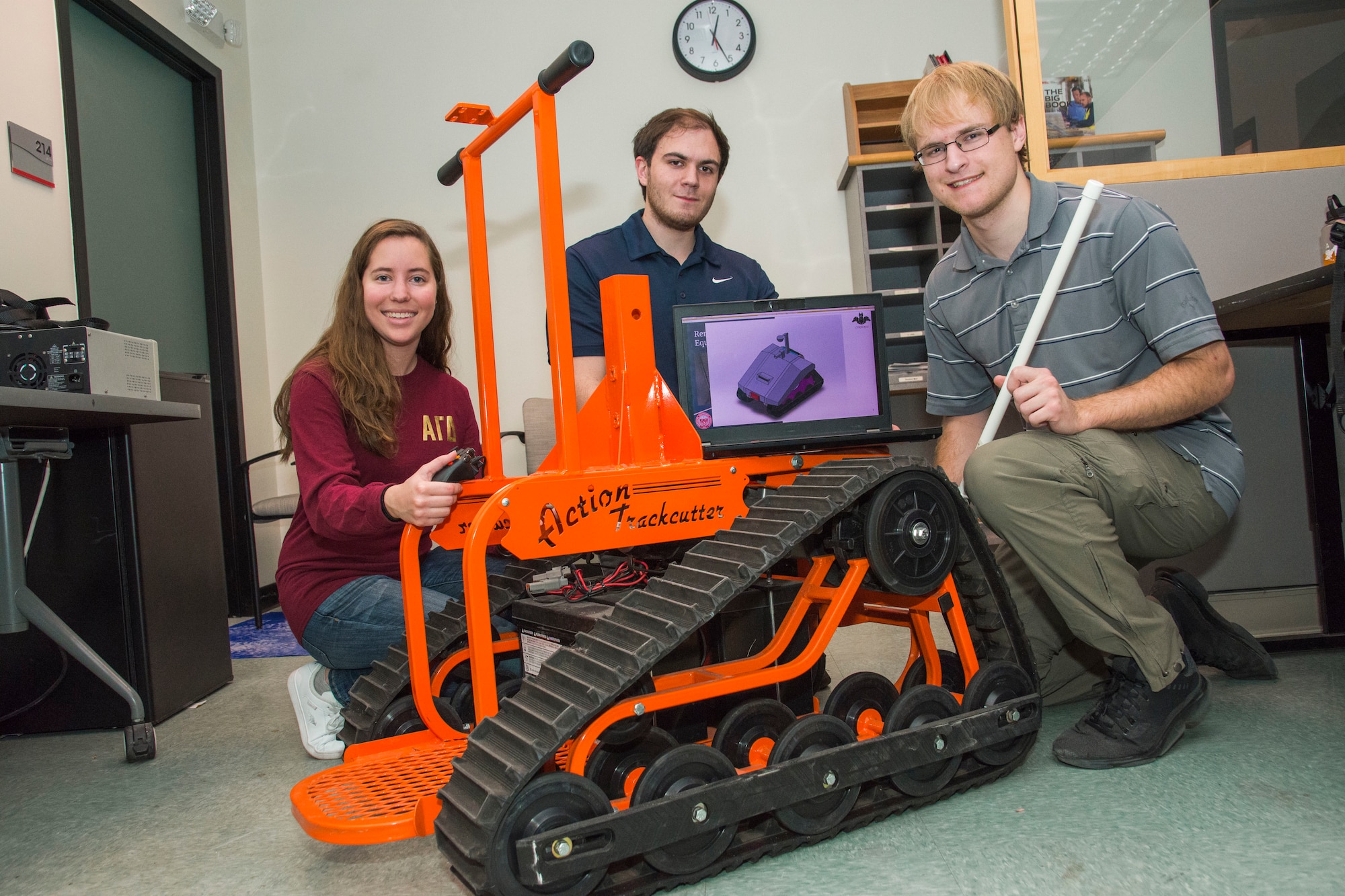 Students pose with robotic sentry wheelchair
