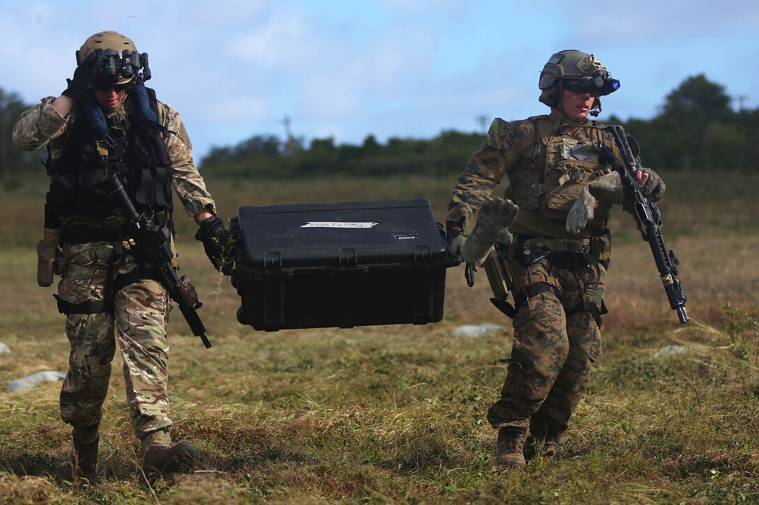 U.S. troops carry training equipment.