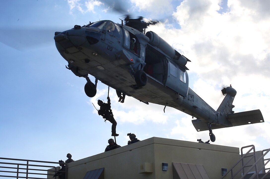 U.S. Marines, sailors and British marines conduct rappelling training.