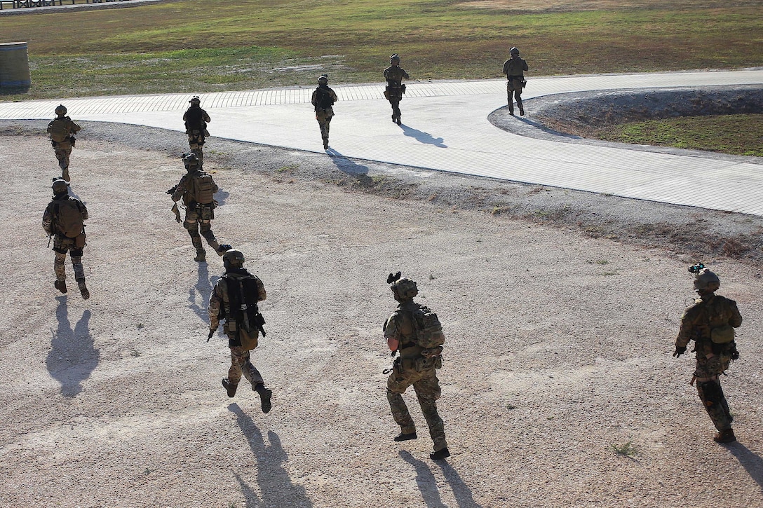 U.S. Marines, sailors and British marines conduct a security patrol.