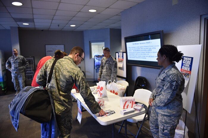 An Airman takes a pamphlet to learn more information about the Air Force Assistance Fund during the Joint Base Charleston AFAF Campaign kicked off March 27, 2018.