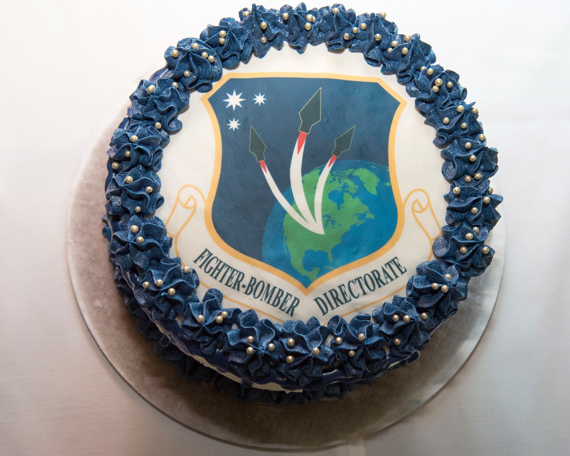 Brig. Gen. Heath Collins assumed leadership as PEO for Fighters Bombers during a March 28 ceremony. Following the ceremony, refreshments were available for attendees including a cake with the Fighter Bomber logo. (U.S. Air Force photo / Michelle Gigante)