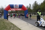 Runners and walkers leave the starting line at the annual 'Honor the Warrior' 5K event at the McNamara Headquarters Complex, Fort Belvoir, Virginia, March 28, 2018.