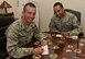 Col. Houston Cantwell, 49th Wing commander, and Chief Master Sgt. Barrington Bartlett, 49th Wing command chief, sign up to make a donation to the Air Force Assistance Fund at Holloman Air Force Base, N.M., March 26, 2018. The four charities that are involved in AFAF are the Air Force Aid Society, General and Mrs. Curtis E. LeMay Foundation, the Air Force Villages, and the Air Force Enlisted Village. (U.S. Air Force photo by Staff Sgt. Timothy Young)