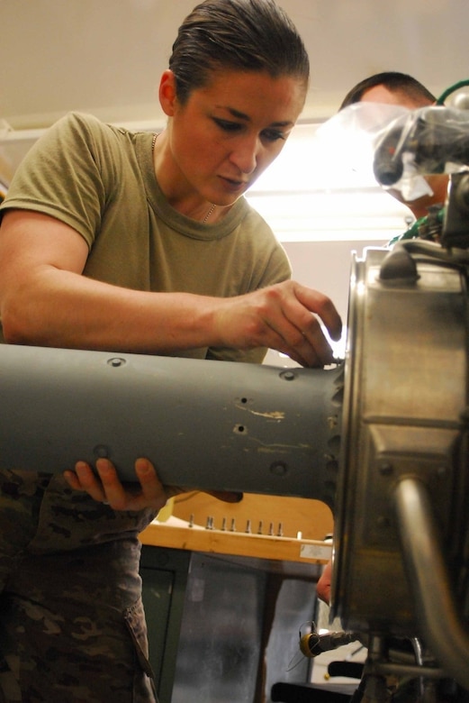 A soldier works on a UH-60 Black Hawk helicopter