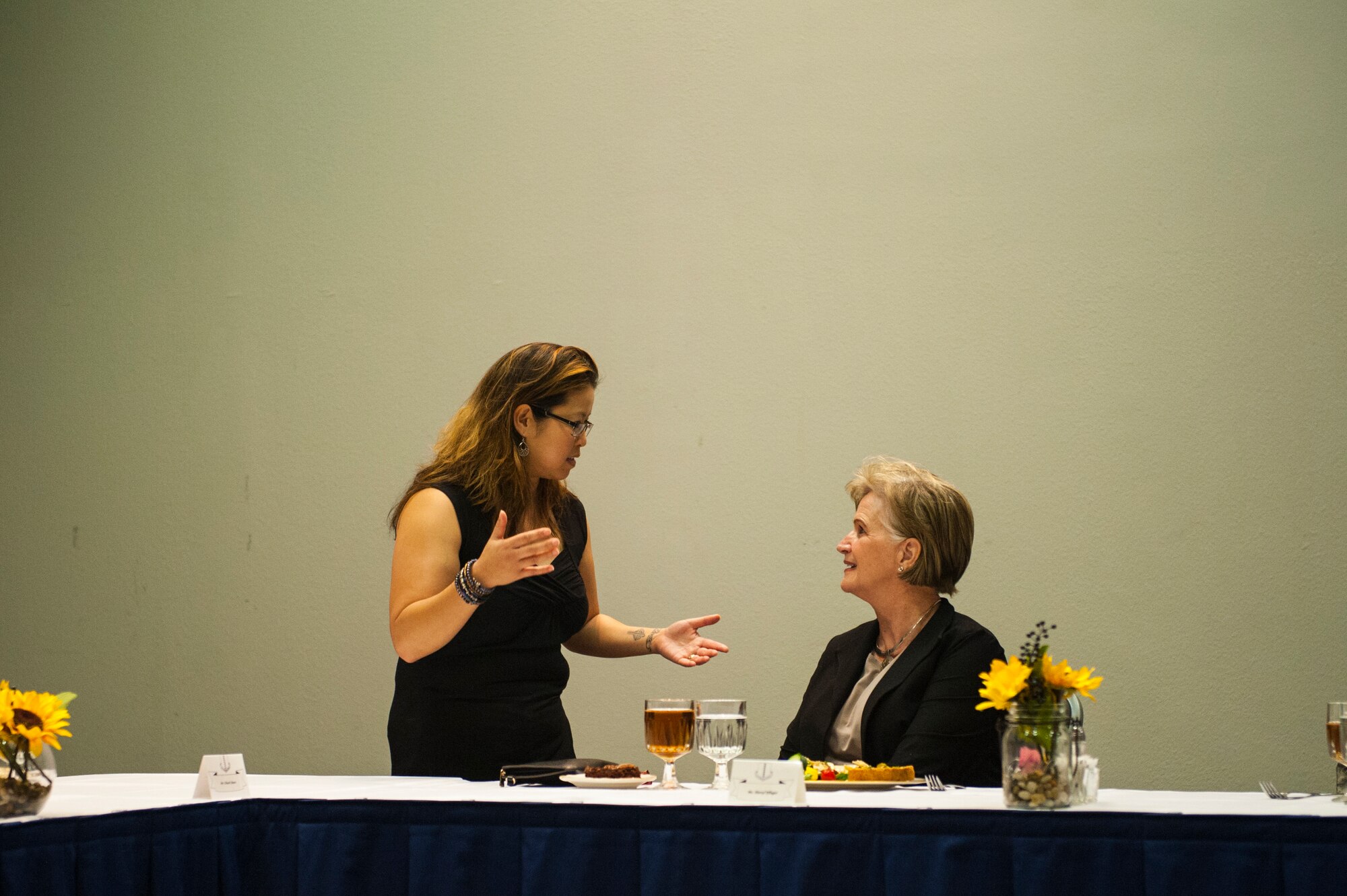 17th Training Wing Public Affairs Community Engagement Chief, Aryn Lockhart, talks with honorary commander to the 17th Medical Operations Squadron, Sheryl Pfluger, during the Civic Leader Luncheon of 2018 at the Event Center on Goodfellow Air Force Base, Texas, March 28, 2018. Leaders from San Angelo attended the luncheon to review and prioritize financial and other goals for both the base and the community. (U.S. Air Force photo by Senior Airman Scott Jackson/Released)
