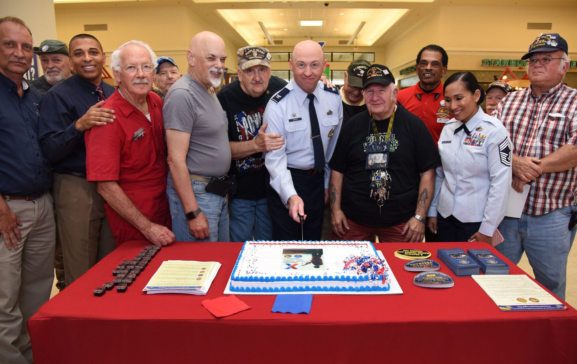 U.S. Air Force Col. Danny Davis, 81st Mission Support Group commander, participates in a cake cutting ceremony during the 50th Anniversary Vietnam Memorial Pinning Day at The Exchange March 29, 2018, on Keesler Air Force Base, Mississippi. The event, which also included a commemorative lapel pin presentation, was held to honor Vietnam veterans for their service. (U.S. Air Force photo by Kemberly Groue)