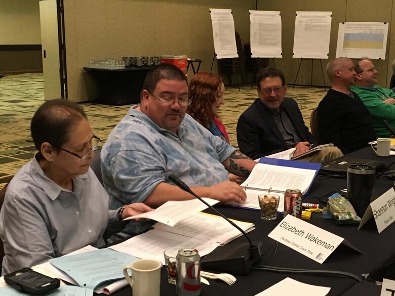 Tribal members of MRRIC seated at a table.