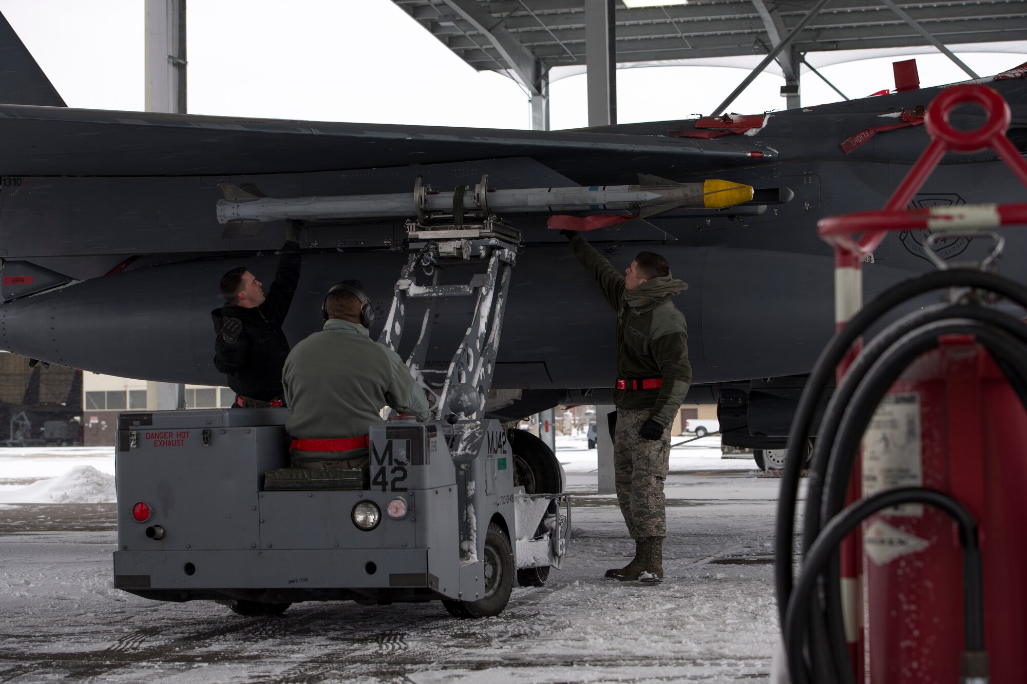 Weapons loadcrew members from the 366th Maintenance Squadron load an AIM-9X Sidewinder onto an F-15E Strike Eagle March 1, 2018, at Mountain Home Air Force Base, Idaho. Using the upgraded missile will strengthen the skills of F-15E Strike Eagle pilots by improving flight performance.