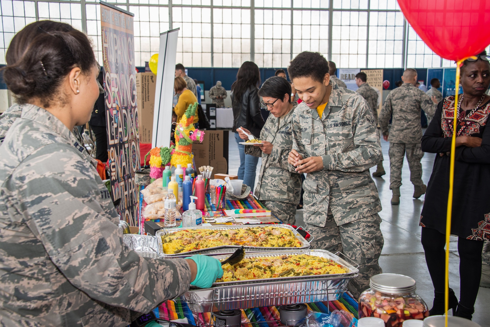 Airman try traditional food at the Hispanic heritage booth March 23, 2018, during Cultural Awareness Day on Maxwell Air Force Base. Nine observances where represented during the event. (U.S. Air Force photo by William Birchfield)