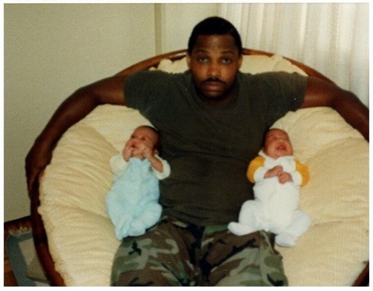 Herman Adams sits with his sons, Julien and Daniel, in their home in Japan in the 1980s. The brothers now serve as U.S. Air Force captains. Julien is a B-1 Lancer weapon systems officer assigned to the 34th Bomb Squadron at Ellsworth Air Force Base, S.D., and Daniel is a B-52 Stratofortress weapon systems officer assigned to the 69th BS at Minot AFB, N.D. The Adams brothers spent their childhood and adolescent years stationed in Japan due to their father being in the U.S. Marine Corps. (Courtesy photo)