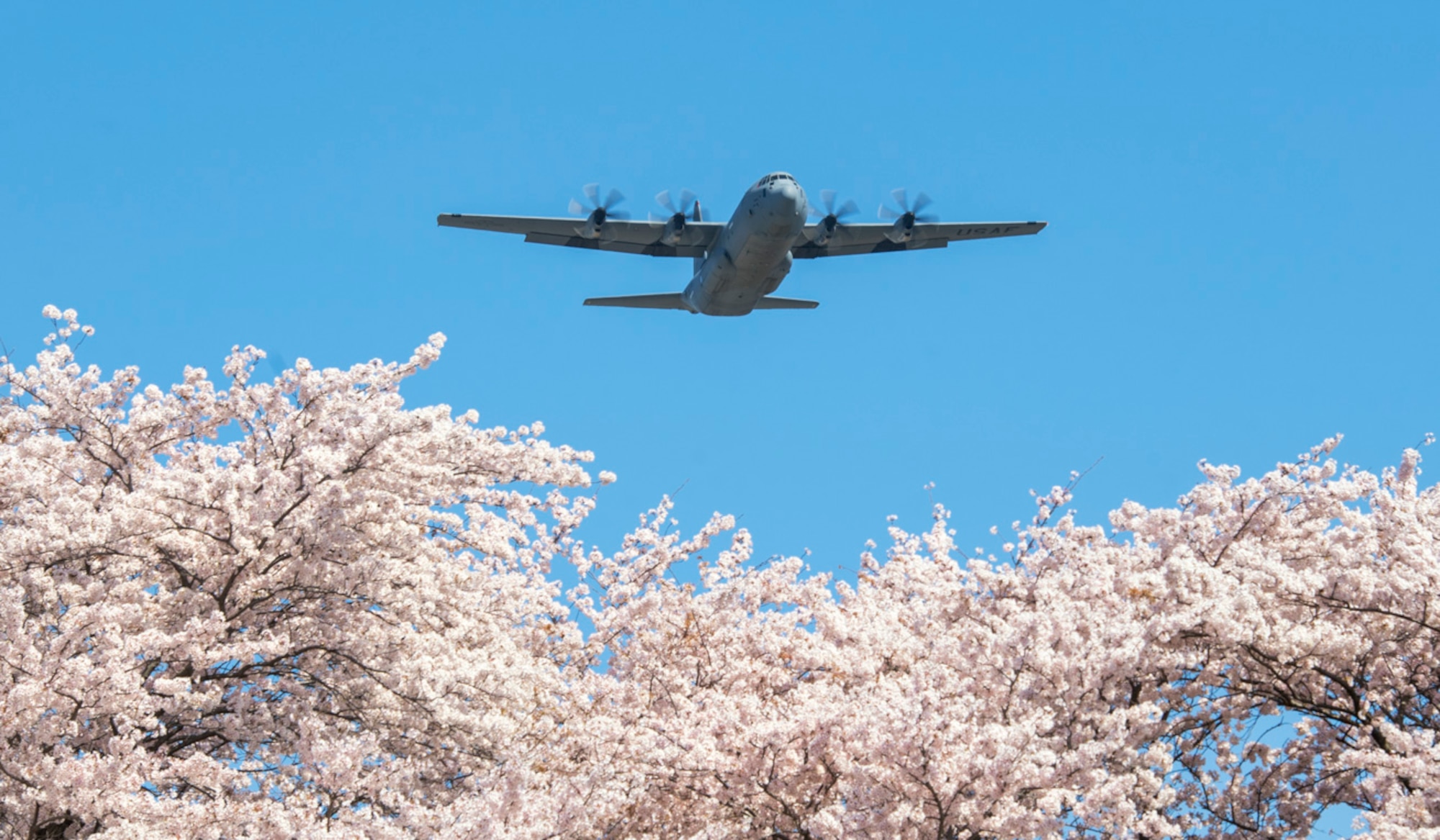 An Air Force C-130J Super Hercules assigned to the 36th Airlift Squadron flies over Yokota Air Base