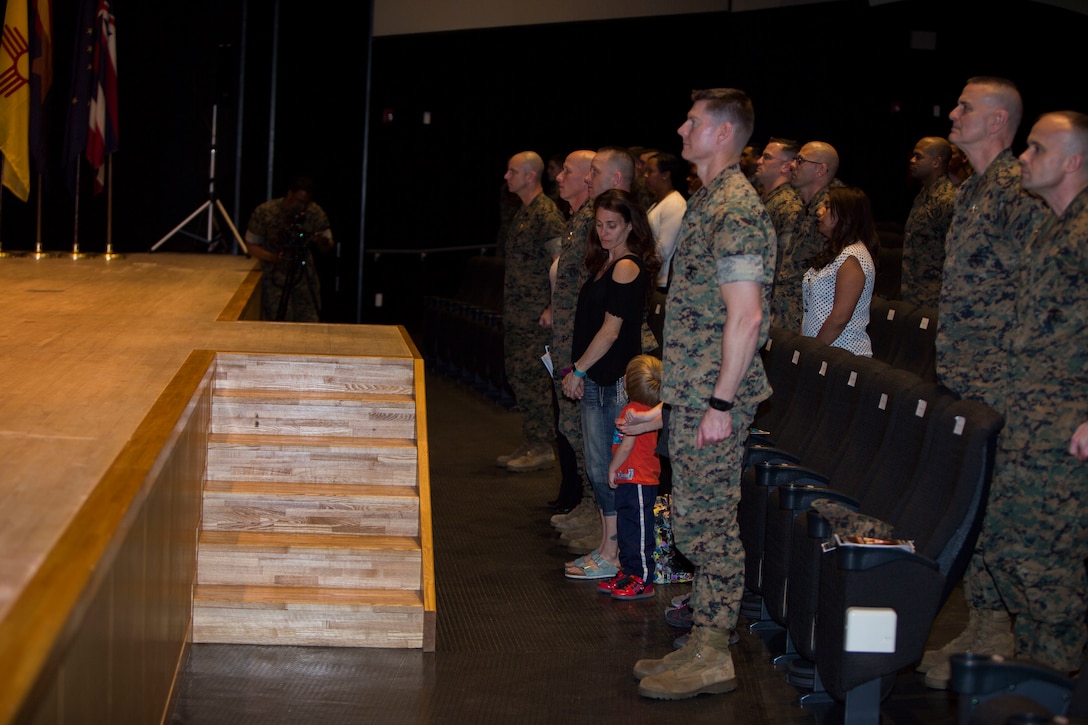 Senior ranking leadership from Marine Corps Air Station (MCAS) Iwakuni and their families stand in observance of the “Marines Hymn” and “Anchors Away” during Sgt. Maj. Joseph S. Gregory’s post ceremony at MCAS Iwakuni, Japan, March 30, 2018. During the ceremony Gregory was appointed as the new sergeant major of MCAS Iwakuni.