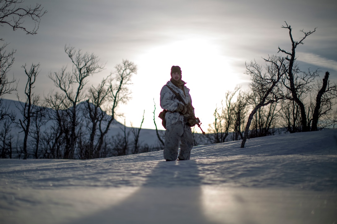 Marine with Marine Rotational Force-Europe moves into position before conducting a mountainous assault on enemy position during the field training exercise.