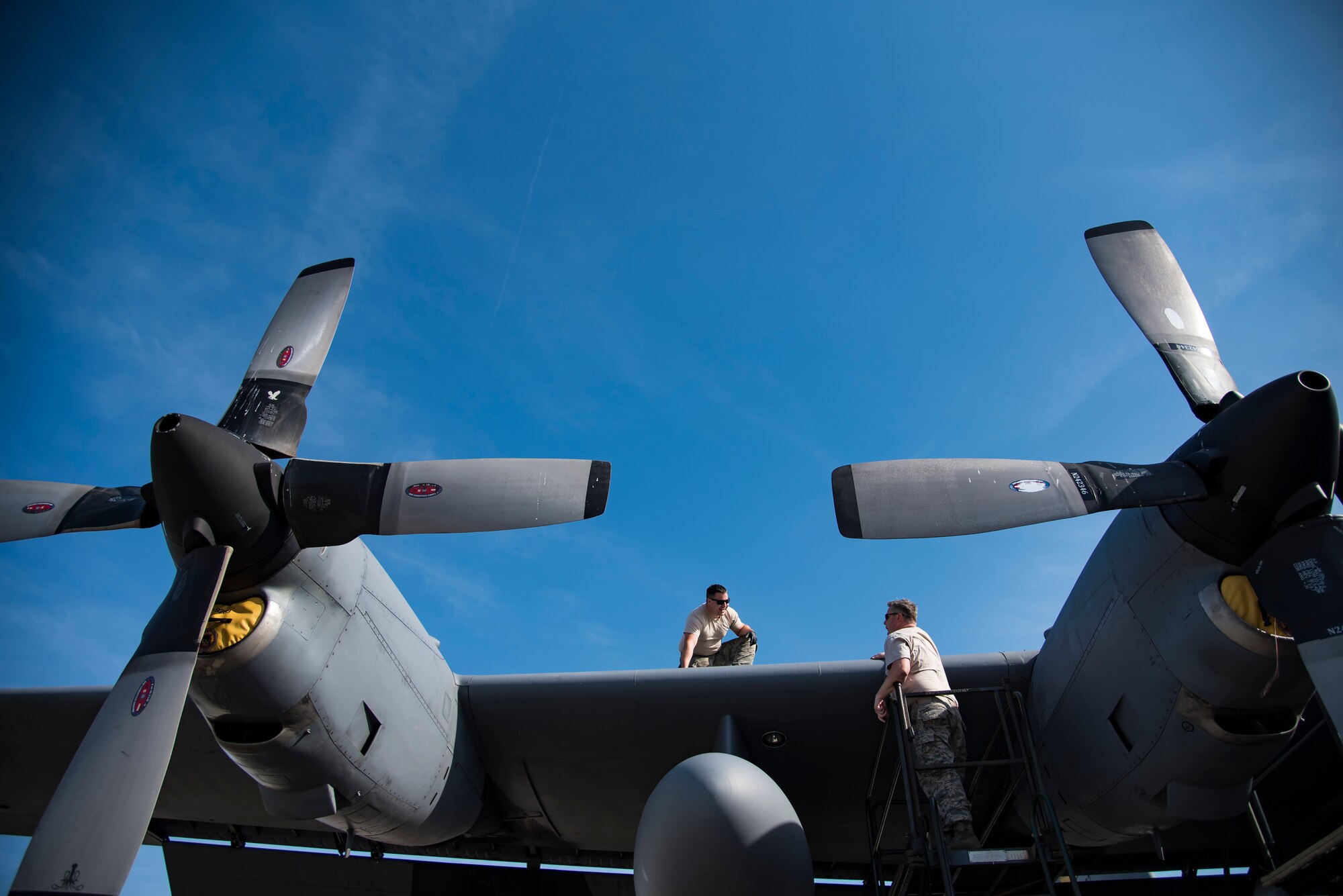 Senior Airman Even Campbell from the 911th Maintenance Squadron, based out of Pittsburgh International Airport Air Reserve Station, Pennsylvania, talks to his supervisor on the wing of an HC-130P/N Combat King at Patrick Air Force Base, Florida, Mar. 1, 2018. The squadron is currently staged here to inspect their aircraft which are returning from overseas assignments, while their base readies for the transition to a new airframe. (U.S. Air Force photo/Staff Sgt. Jared Triamrchi)