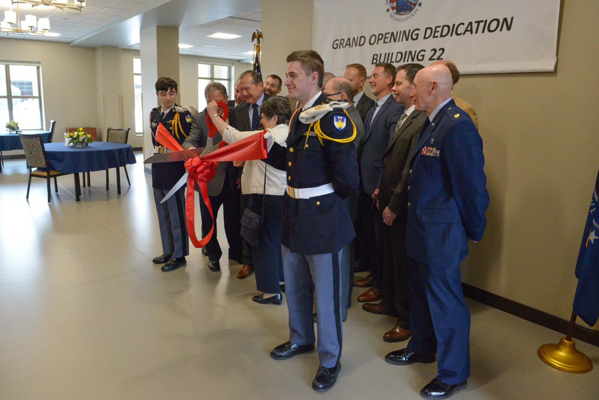 The ceremonial ribbon is cut at the Minnesota Veterans Home March 22 marking the completion of Building 22 and the opening of the new facility. (Air Force Photo/Master Sgt. Eric Amidon)