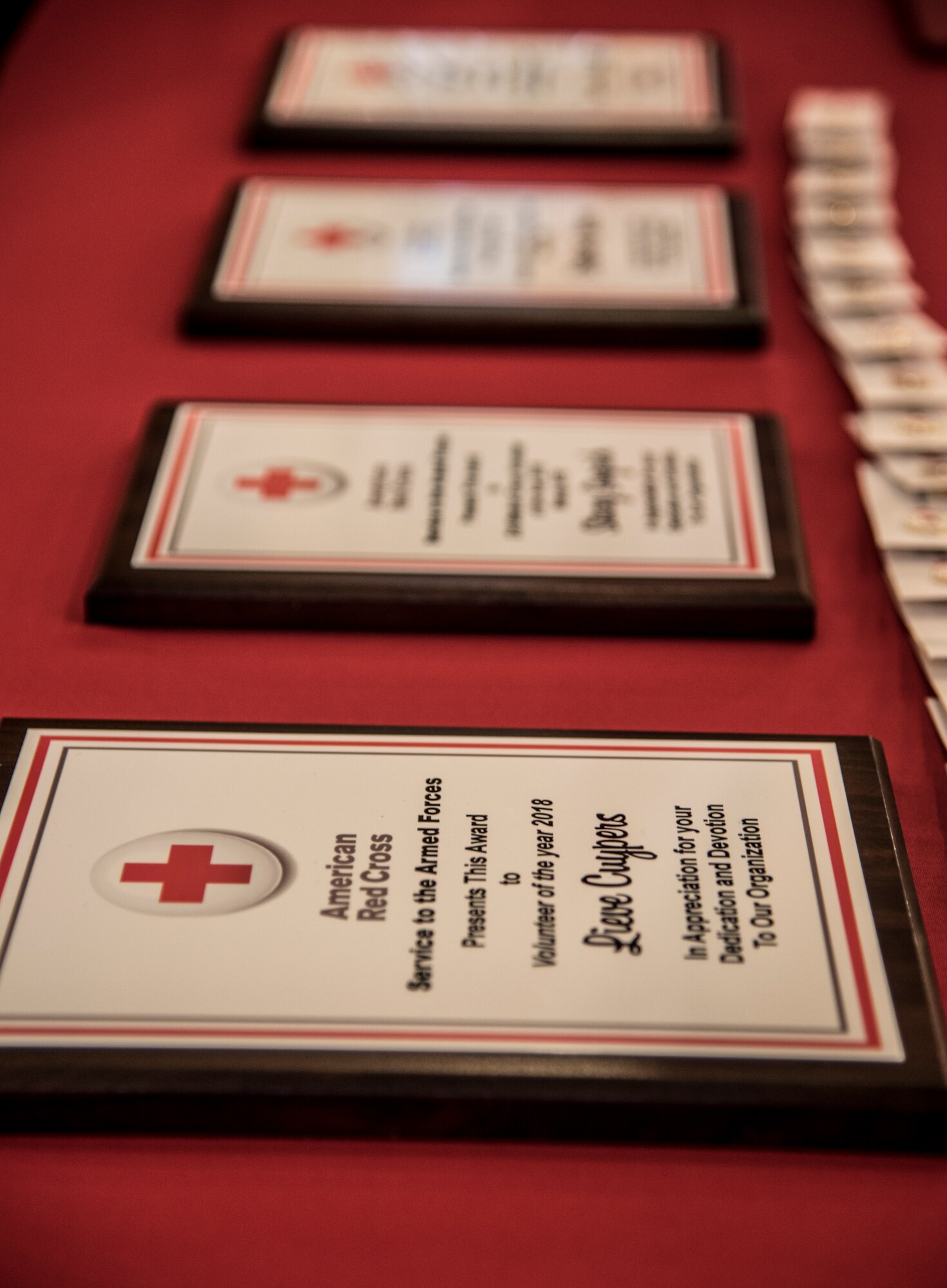 Achievement plaques rest on a table at an American Red Cross volunteer appreciation luncheon, March 26, 2018, at Moody Air Force Base, Ga. Volunteers from Moody were recognized for their service to the American Red Cross. (U.S. Air Force photo by 1st Lt. Kaitlin Toner)