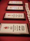 Achievement plaques rest on a table at an American Red Cross volunteer appreciation luncheon, March 26, 2018, at Moody Air Force Base, Ga. Volunteers from Moody were recognized for their service to the American Red Cross. (U.S. Air Force photo by 1st Lt. Kaitlin Toner)