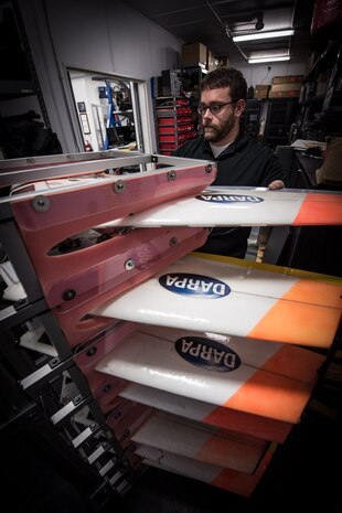 Space and Naval Warfare Systems Center (SSC) Atlantic employee Chad Sullivan places an unmanned aerial vehicle (UAV) into a protective storage rack. Sullivan is a member of the SSC Atlantic Unmanned Systems Research (SAUSR) Range team which is working with the Defense Advanced Research Projects Agency (DARPA) to get autonomous technology in the hands of warfighters. SSC Atlantic develops, acquires and provides life cycle support for command, control, communications, computer, intelligence, surveillance and reconnaissance (C4ISR) systems, information technology and space capabilities. A leading-edge Navy engineering center, SSC Atlantic designs, builds, tests, fields and supports many of the finest frontline C4ISR systems in use today, and those being planned for the future.