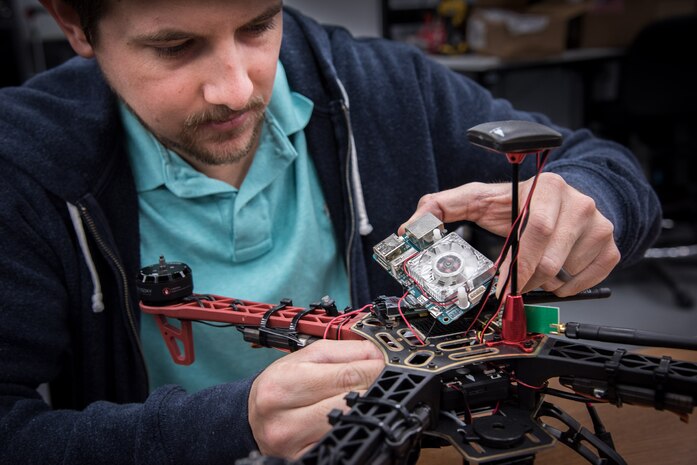Space and Naval Warfare Systems Center (SSC) Atlantic employee Josh Carter performs maintenance on an unmanned aerial vehicle (UAV). Carter is a member of the SSC Atlantic Unmanned Systems Research (SAUSR) Range team which is working with the Defense Advanced Research Projects Agency (DARPA) to get autonomous technology in the hands of warfighters. SSC Atlantic develops, acquires and provides life cycle support for command, control, communications, computer, intelligence, surveillance and reconnaissance (C4ISR) systems, information technology and space capabilities. A leading-edge Navy engineering center, SSC Atlantic designs, builds, tests, fields and supports many of the finest frontline C4ISR systems in use today, and those being planned for the future.