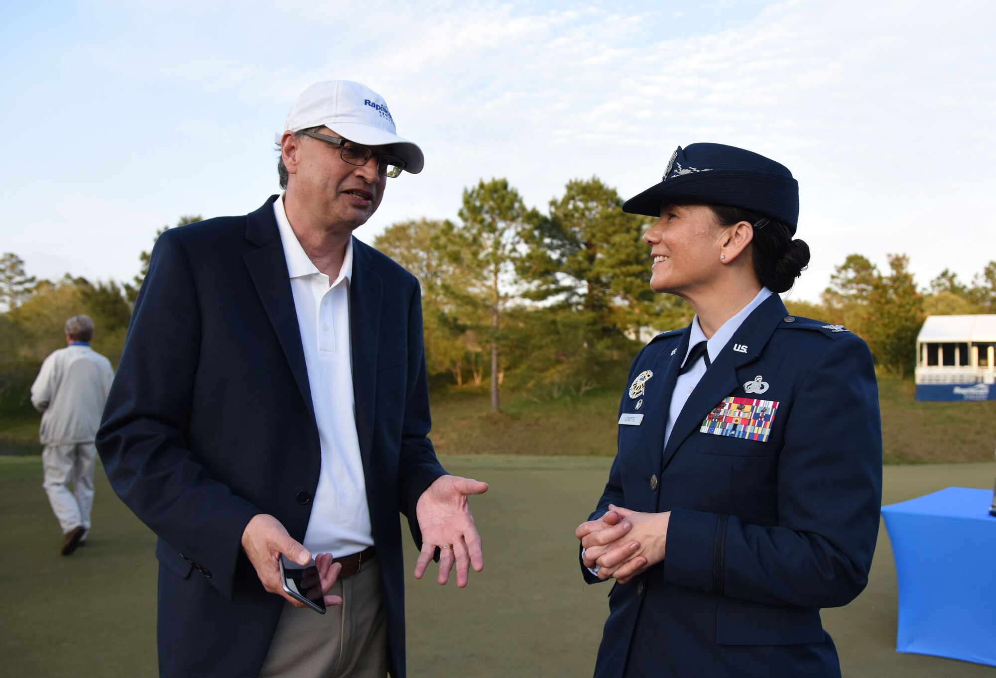 U.S. Air Force Col. Debra Lovette, 81st Training Wing commander, speaks with Ajay Mehra, Rapiscan Systems president, during the Rapiscan Systems Classic Champions Tour at Fallen Oak Golf Club March 25, 2018, in Saucier, Mississippi. Keesler personnel performed the national anthem and presented the colors during the closing ceremony of the three-day event. (U.S. Air Force photo by Kemberly Groue)