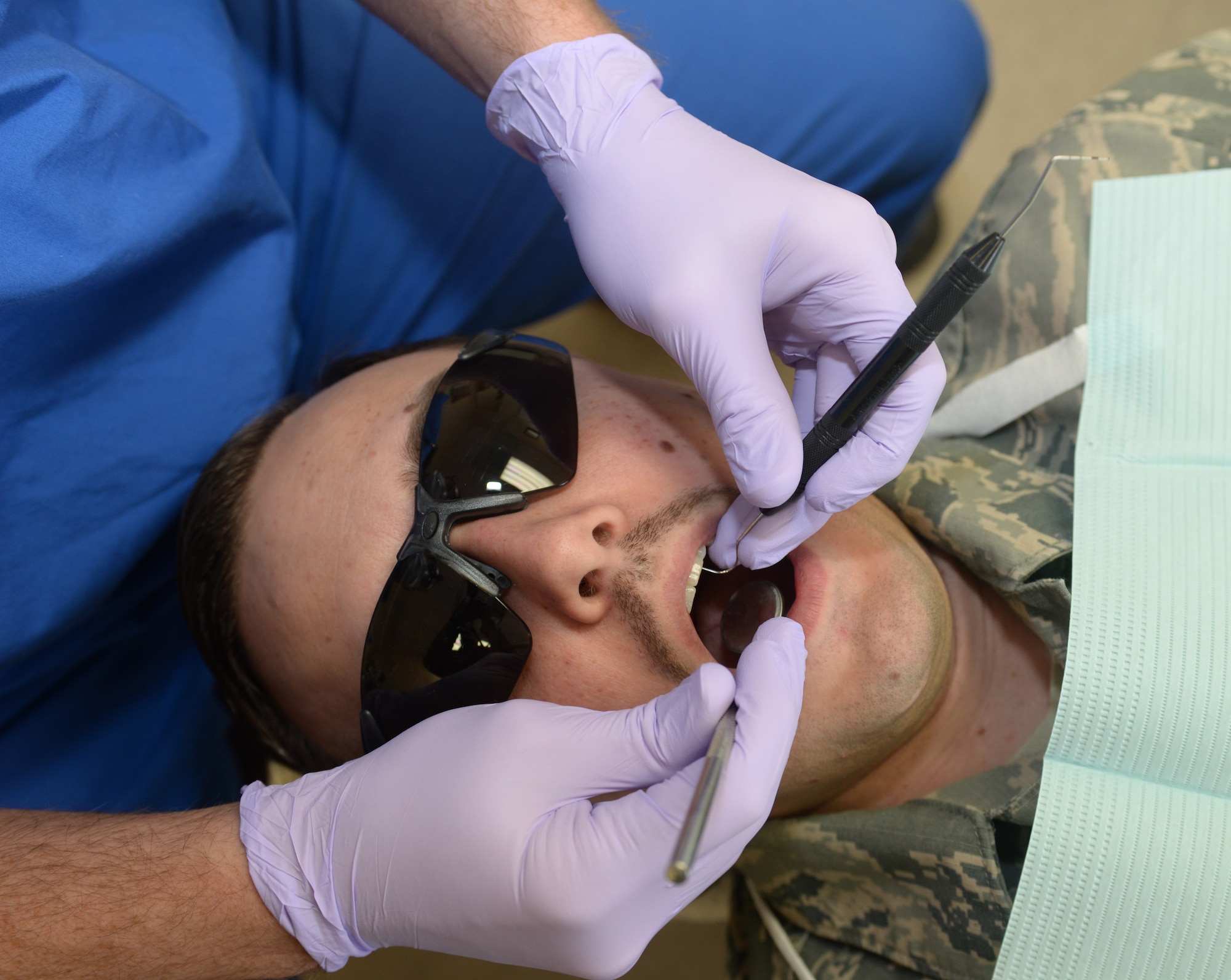 Staff Sgt. William Garrett, a 28th Medical Group Dental Clinic dental technician, checks the teeth of Tech. Sgt. Michael Wilde, the 28th MDG noncommissioned officer in charge of clinical support, during an appointment at Ellsworth Air Force Base, S.D., March 6, 2018. The dental clinic at Ellsworth AFB has been in operation since 1948. (U.S. Air Force photo by Airman 1st Class Thomas Karol)