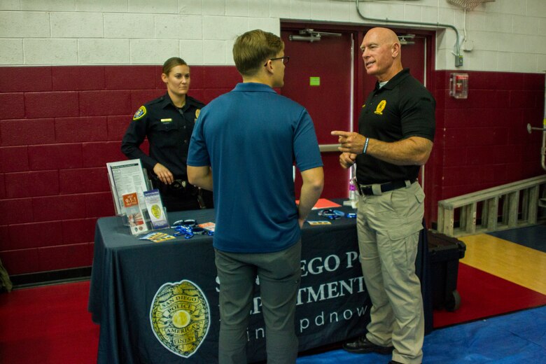 A Marine speaks to Steve Markland, police recruiter, Recruiting Unit, San Diego Police Department, about job opportunities with the department during the Education & Career Fair aboard the Marine Corps Air Ground Combat Center, Twentynine Palms, Calif., March 21, 2018. The Education & Career Fair is a tool for Marines looking to further their education, develop new skills and explore new career fields. (U.S. Marine Corps photo by Lance Cpl. Rachel K. Porter)