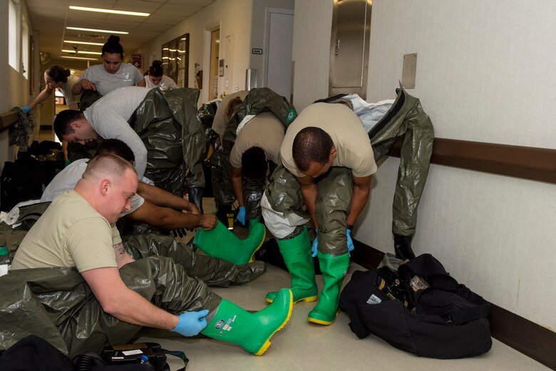 Airmen from the 4th Medical Group Decontamination Team suit-up into their chemical, biological, radiological and nuclear defense gear as part of an exercise, March 27, 2018, at Seymour Johnson Air Force Base, North Carolina.