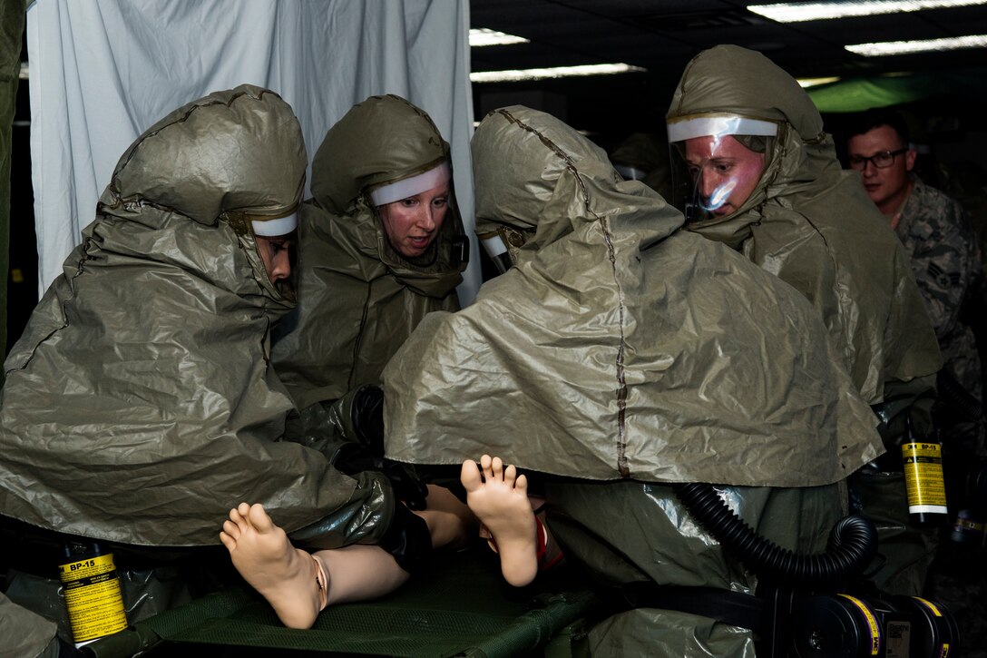 Members from the 4th Medical Group Decontamination Team, process a simulated “patient” through the in-place patient decontamination tent, March 27, 2018, at Seymour Johnson Air Force Base, North Carolina.