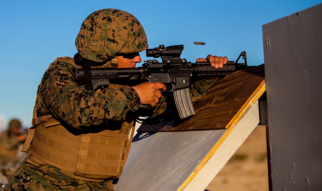 A Marine with Alpha Company, Headquarters Battalion, shoots an M4 Carbine for tables three and four aboard  the Marine Corps Air Ground Combat Center, Twentynine Palms, Calif., March 23, 2018. The annual marksmanship qualification allows Marines to validate and improve proficiency in shooting and maneuvering with their weapon.  (U.S. Marine Corps photo by Lance Cpl. Jennessa Davey)