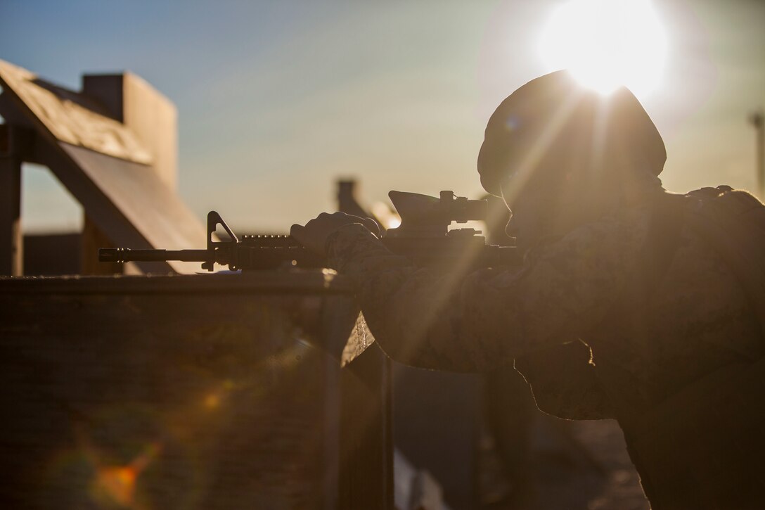 Pfc Antonio T. Reviere, Administration Clerk, Alpha Company, Headquarters Battalion, shoots an M4 Carbine for tables three and four aboard  the Marine Corps Air Ground Combat Center, Twentynine Palms, Calif., March 23, 2018. The annual marksmanship qualification allows Marines to validate and improve proficiency in shooting and maneuvering with their weapon.  (U.S. Marine Corps photo by Lance Cpl. Jennessa Davey)
