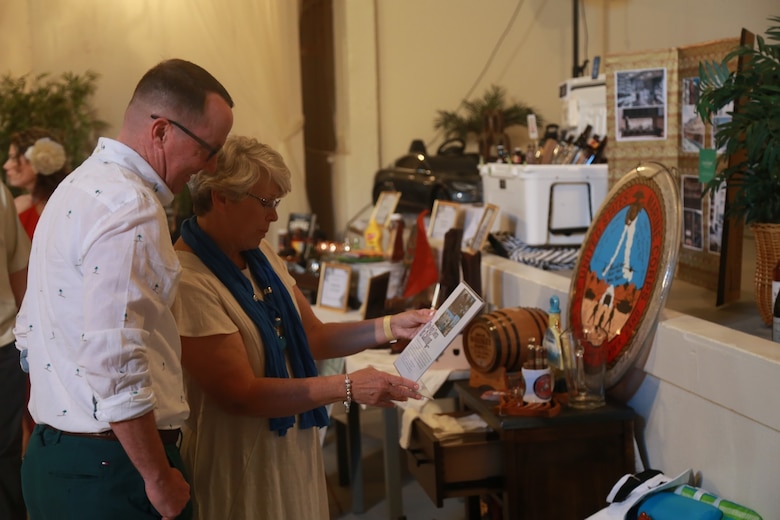 Guests look at one of many auction bundles during the Havana Nights Gala & Benefit Auction hosted by Smith’s Ranch in Twentynine Palms, Calif., March 24, 2018. Havana Nights is an annual benefit auction hosted by the Officers’ Spouses’ Club to raise money for their Scholarship Grant Program, which provides community members with grants to continue their education. (U.S. Marine Corps photo by Lance Cpl. Preston L. Morris)