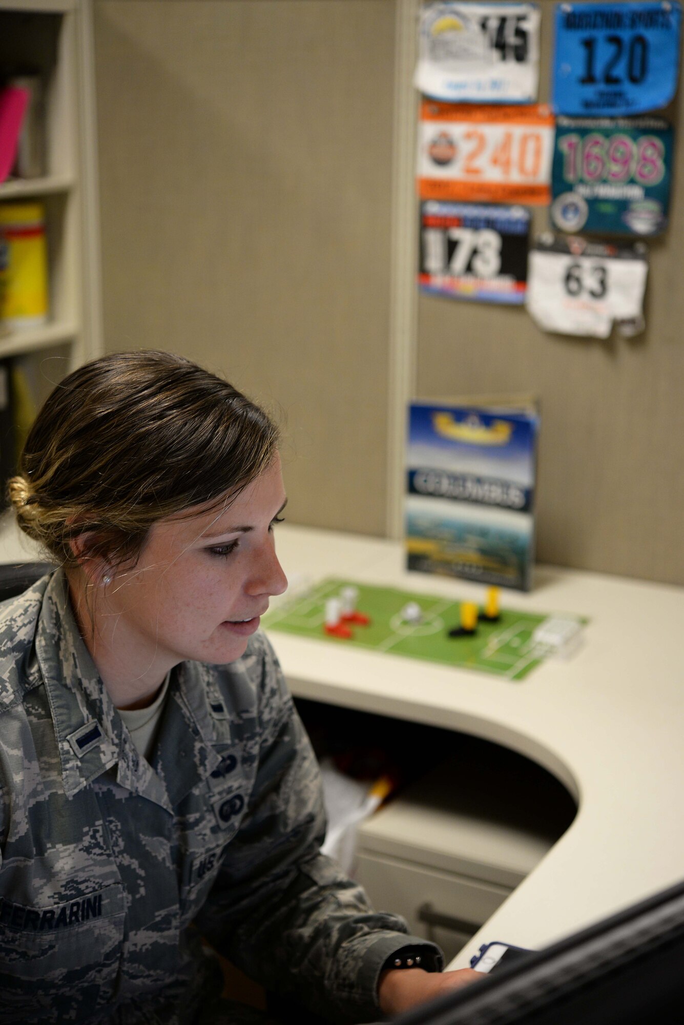 First Lt. Hannah Ferrarini, 14th Force Support Squadron officer in-charge of Career Development works at her desk March 27, 2018, on Columbus Air Force Base, Mississippi. She has completed numerous races since her injury over 5 years ago even though her doctors originally predicted she might not ever run again. (U.S. Air Force photo by Airman 1st Class Keith Holcomb)