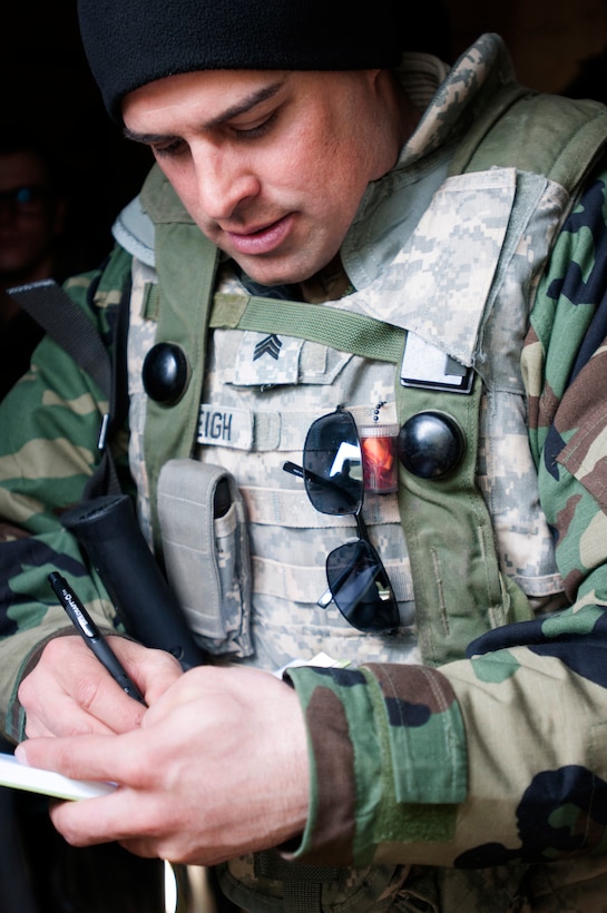 A medic assigned to the Army Reserve’s 256th Combat Support Hospital, headquartered in Twinsburgh, Ohio, fills in medical forms.