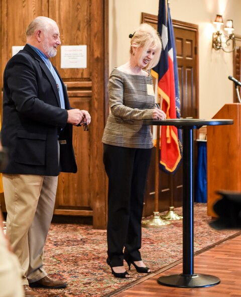Tom Nurre, the commemoration program coordinator, stands with San Angelo Major Brenda Gunter as she signs the San Angelo proclamation for Vietnam veterans at the LeGrand Alumni Center, San Angelo, Texas, March 29, 2018. The localized proclamation echoed President Trump’s about the objectives to go forward through the commemoration process.