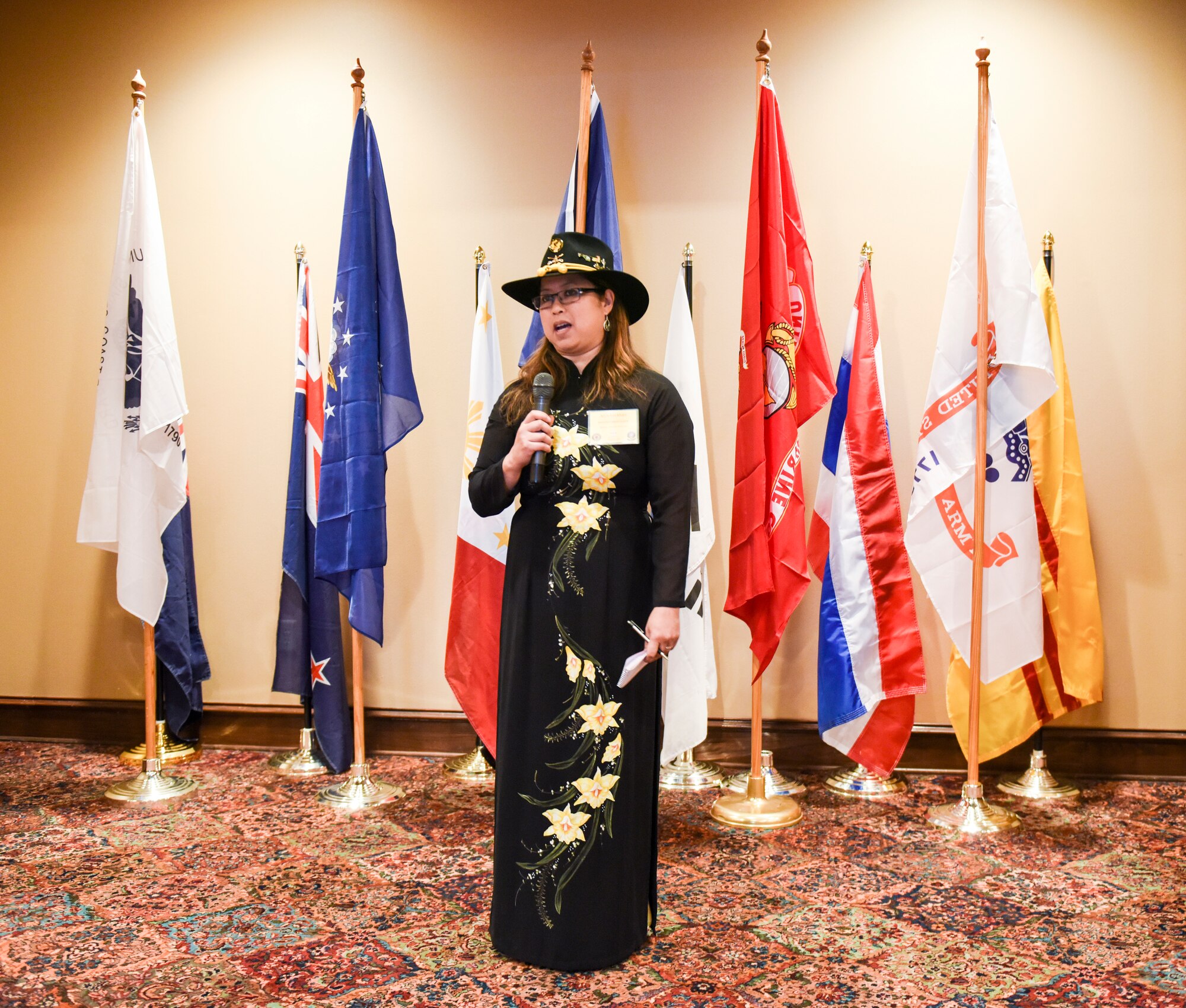 Wearing her traditional Vietnamese ao dai, Aryn Lockhart, 17th Training Wing Public Affairs community engagement chief, speaks to the Vietnam veterans and their families during the 50th Commemoration of the Vietnam War ceremony held at the LeGrand Alumni Center, San Angelo, Texas, March 29, 2018.  Lockhart was the keynote speaker and shared her story of being a Vietnamese adoptee and member of Operation Babylift.