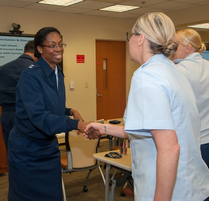 Health Service Technicians 1st Class Heidi Bennett, center, and Nicole Flores, right, Fleet Liaison Readiness Support for Coast Guard Charleston, greet Rear Adm. Erica Schwartz, left, Director of Health, Safety and Work-Life for the U.S. Coast Guard, during Schwartz's visit Naval Health Clinic Charleston March 20. Schwartz and her staff met with Coast Guard and NHCC leaders before touring the health care facility. Bennet, Flores and two other Coast Guard health service technicians are embedded at NHCC to provide medical and dental care for Coast Guard personnel and their families stationed at Sector Charleston. Schwartz is responsible for the Coast Guard's health care system of 41 clinics and 150 sick bays, as well as, operational and off-duty mishap prevention, response and investigation. Schwartz oversees the Coast Guard's child care programs and food services delivery programs, ashore and afloat and the Coast Guard's Ombudsman, Substance Abuse, Health Promotion and Sexual Assault Prevention and Response programs.