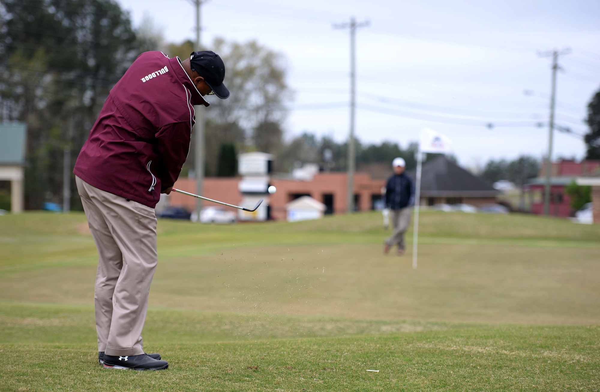 Milton Rawl chips on the 8th hole March 26, 2018 at Lion Hills Columbus Country Club in Columbus, Mississippi. Rawl was participating in the Happy Irby Golf Tournament fundraiser, focused on helping donate items to children in need across the local community. (U.S. Air Force photo by Airman 1st Class Keith Holcomb)