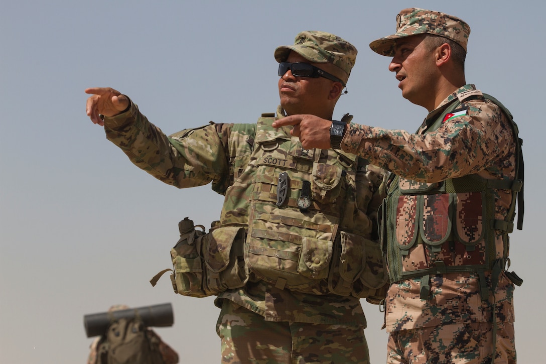 Master Sgt. Tom Scott Jr., subject matter expert, 648th Military Engagement Team, Georgia Army National Guard, and Command Sgt. Maj. Mohammad Al-Smadi, commandant, Jordan Armed Forces Noncommissioned Officer Academy, observe and discuss training during the JAF NCOA Squad Leader Course, March 18, 2018, near Amman, Jordan. The 648th MET advised JAF NCOA instructors as the Jordanian leaders developed the program of instruction for the course, which is attended by their soldiers and their regional allies. (U.S. Army photo by Sgt. Thomas X. Crough, USARCENT PAO)