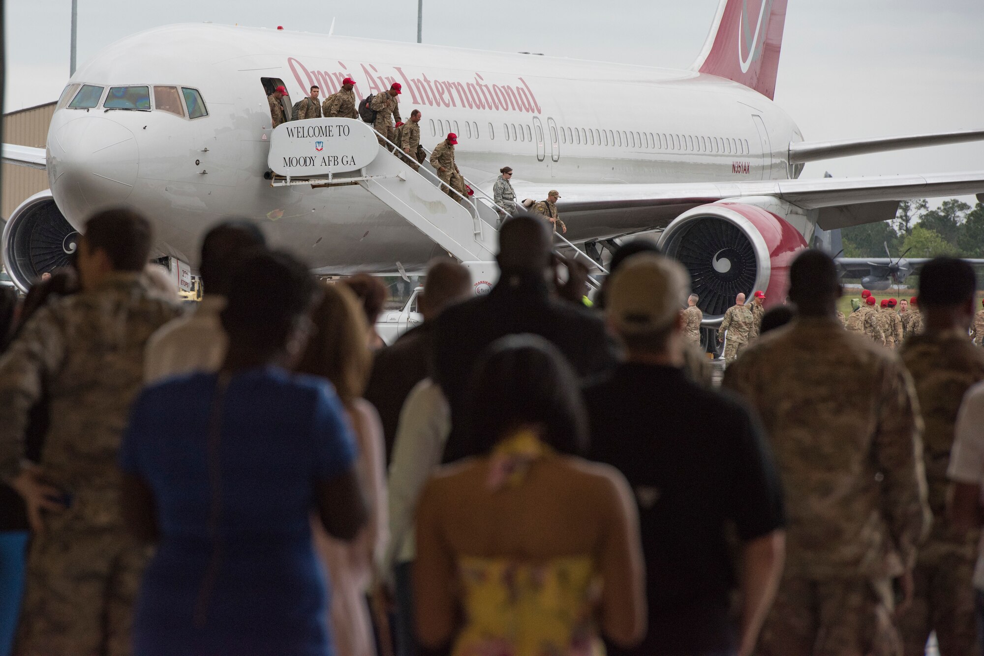 Family and friends watch as 822nd Base Defense Squadron Airmen return to Moody Air Force Base, Ga., after a deployment, March 30, 2018. The 822nd BDS returned after spending several months deployed and earning numerous command, wing and individual awards. (U.S. Air Force photo by Staff Sgt. Eric Summers Jr.)