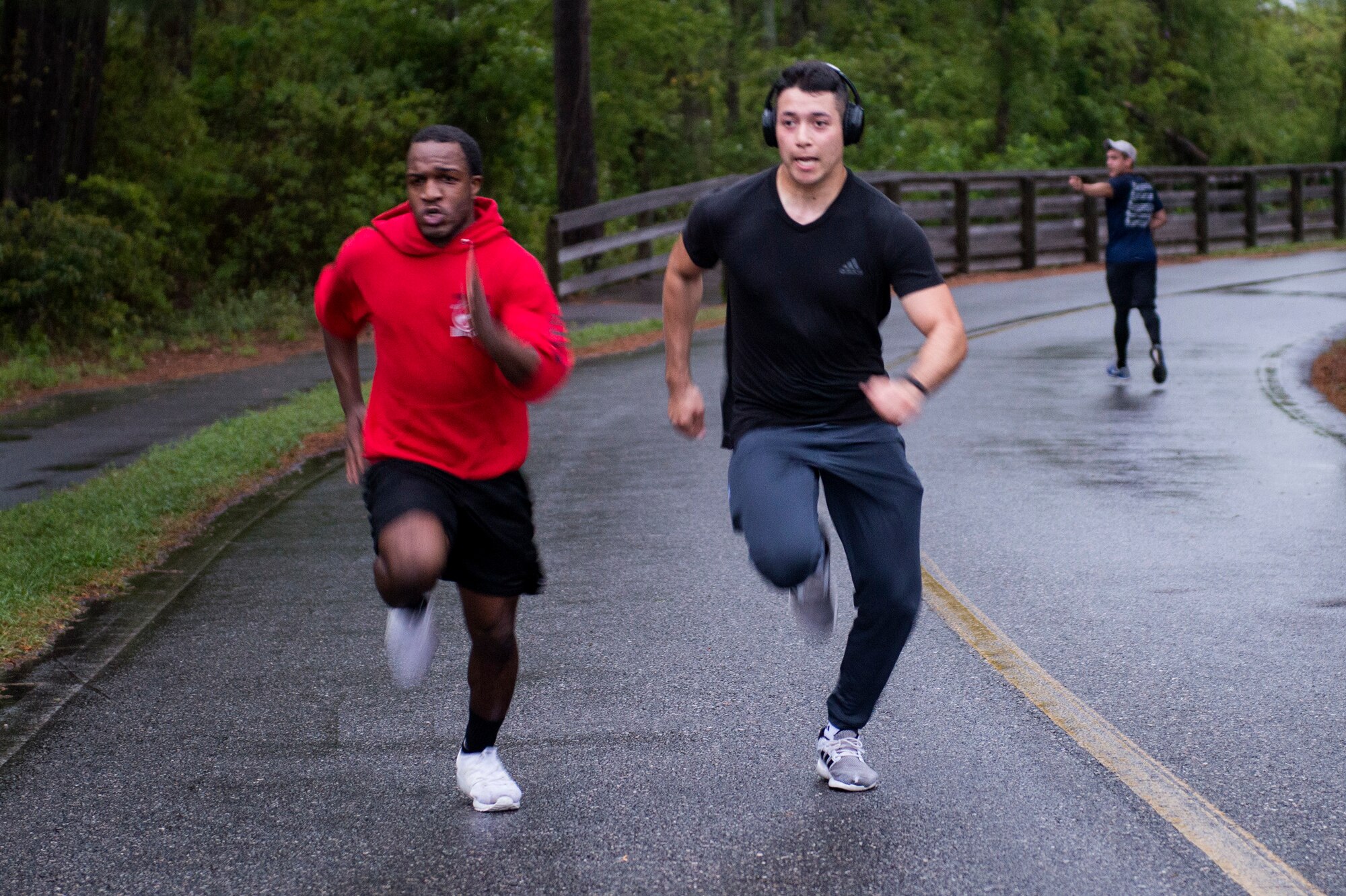 Airman 1st Class Frederick Marseille, left, 23d Maintenance Squadron aerospace propulsion journeyman, and Airman 1st Class Kenneth Batista, 23d Maintenance Squadron conventional ammo technician, run the final stretch of the Empower Women 5k, March 30, 2018, at Moody Air Force Base, Ga. The event concluded National Women’s History Month, celebrating and honoring the social, economical, cultural and political achievements of both military and civilian women both military and civilian. (U.S. Air Force photo by Airman 1st Class Erick Requadt)